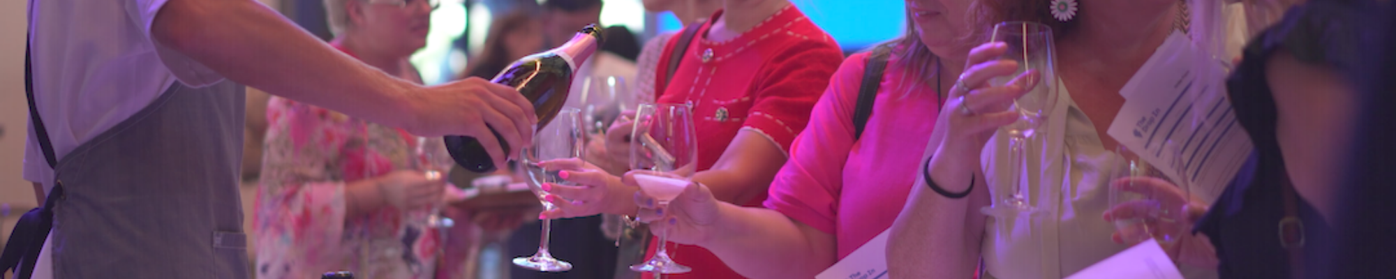 a group of people holding wine glasses
